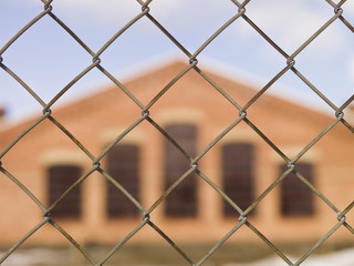 Naklejka premium Building behind fence