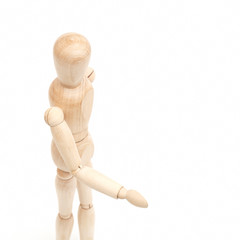 A wooden mannequin give a hand, greets.