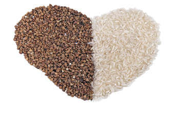 heart shape dry buckwheet and rice isolated over white