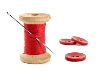 Spool of thread, needle and buttons