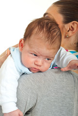 Newborn baby on his mother shoulder