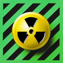Radioactive button on green and black background