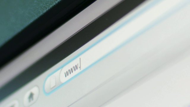 Typing web address in internet browser on pc screen