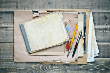 old notebook, envelope with paper and pens