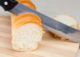 Cutting of a slice of bread by a knife