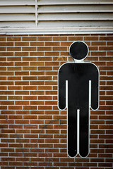 International AIGA Man Symbol on Brick Wall