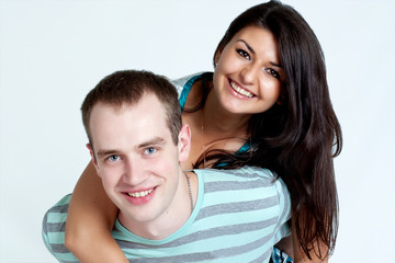 Happy young coule smiling at camera on white background