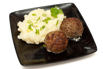 Meatballs with mashed potato on the plate closeup