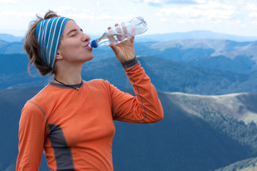Hiker drinks clear water on top of the mountains