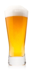 Beer into glass isolated on white