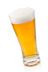 Beer into glass isolated on white