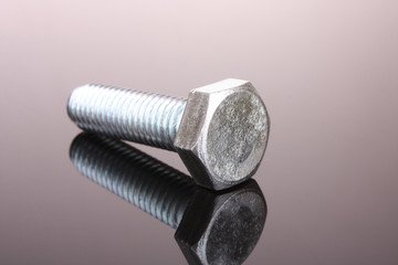 Screw with reflection on grey background