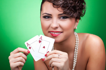 sexy woman holding a pair of aces