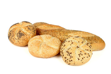Kaiser rolls with poppy and sesame seeds and a loaf of bread wit