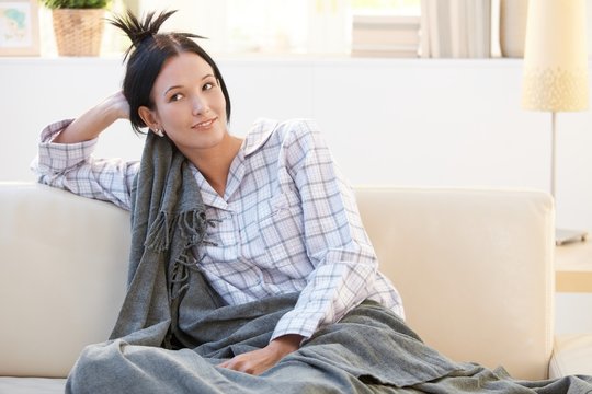 Morning portrait of pyjama girl with blanket