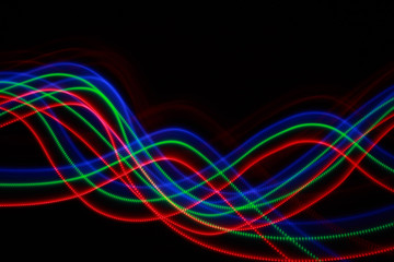 Abstract colorful lines on black background, blue, green and red