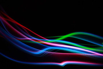 Abstract colorful lines on black background, freezelight