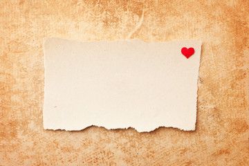 Ripped pieces of paper on grunge paper background. Love letter