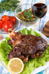 Roast leg of lamb on decorated table