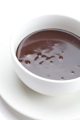melted chocolate in a cup isolated on white