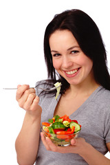 Young attractive woman eats vegetable salad