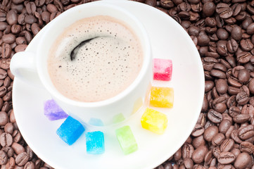 Multicolored slabs of shugar and cup of coffee