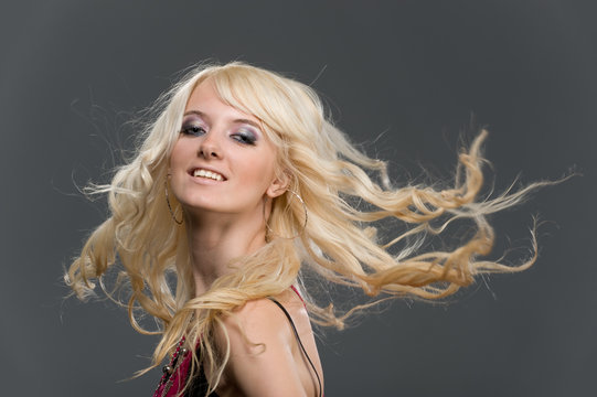 Portrait Of Beautiful Young Blonde Girl With Flying Long Hair