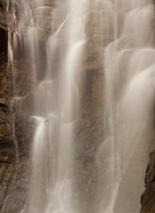 Fototapeta na wymiar Closeup of a waterfall with blurred motion like white veil