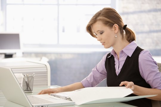 Office worker doing paperwork at desk