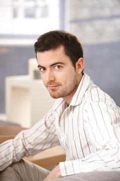 Portrait of young man sitting at home