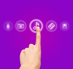 Hand choosing melody-sound film symbol from media icons