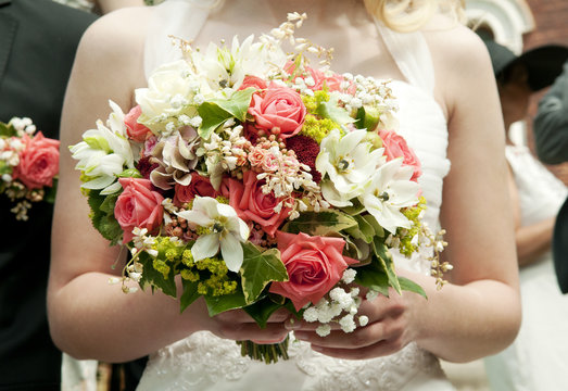 bride holding bunch of flowers at wedding