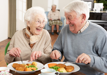 Senior Couple Enjoying Meal Together - obrazy, fototapety, plakaty