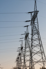 Pylon and transmission power line in sunset