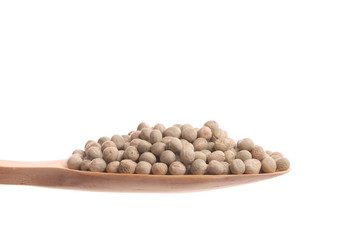 Green peas on a wooden spoon