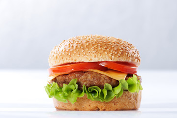 Cheeseburger with tomatoes and lettuce