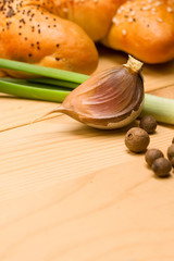Bun, onion and garlic isolated on wooden background