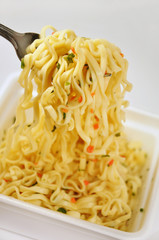 Appetizing Instant noodles with spices. Noodles on a fork