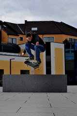 skateboard ollie over a block