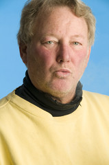 handsome whistling middle age senior man worn turtleneck shirt