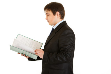 Serious businessman exploring documents isolated on white.