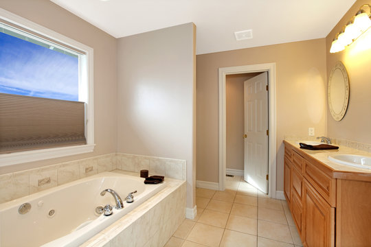 Large new bathroom with grey walls and large tub