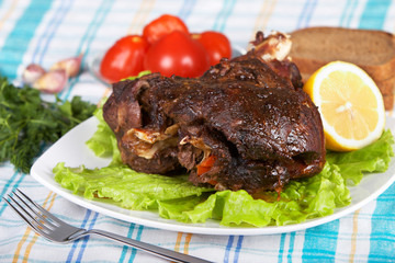 Roast leg of lamb on decorated table
