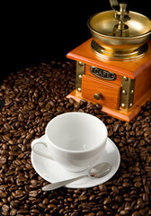 cup of coffee and grinder on beans