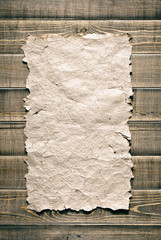 Vintage paper on brown wood texture
