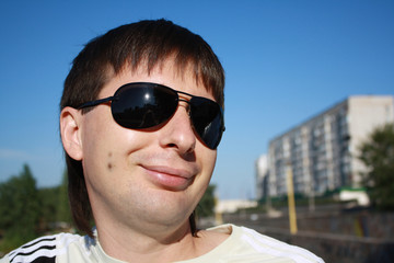 Yong mam in sun glasses is smiling