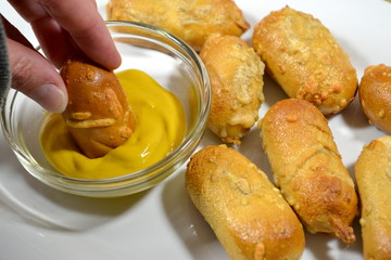Dipping Cheesy Pretzels in Mustard