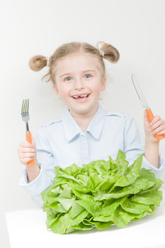 Healthy food - little girl with butterhead lettuce