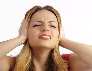 Girl covering her ears with her hands, headache