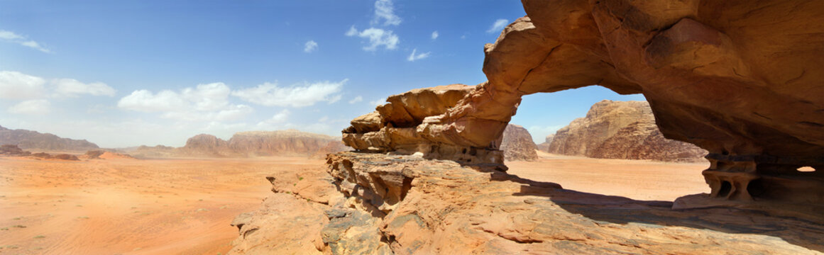 natural bridge and panoramic view of Wadi Rum desert, Jordan